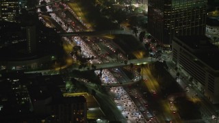 AX64_0414 - 5K aerial stock footage of heavy traffic on Highway 110 and overpasses, Downtown Los Angeles, California, night