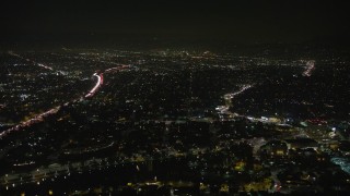 AX64_0415E - 5K aerial stock footage of 101 freeway and urban neighborhoods in Echo Park, Los Angeles, California, night