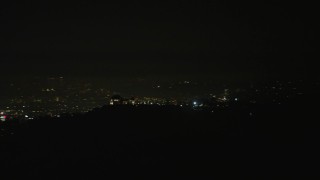 AX64_0424 - 5K aerial stock footage of the Griffith Observatory at night, Los Angeles, California