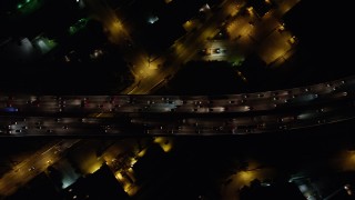 AX64_0429 - 5K aerial stock footage of bird's eye of I-5 freeway with heavy traffic, Burbank, California, night