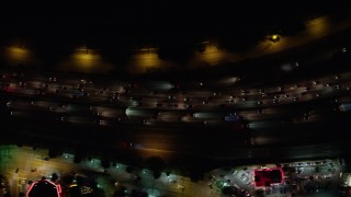 AX64_0431 - 5K aerial stock footage of a bird's eye view of heavy I-5 traffic at night, Burbank, California