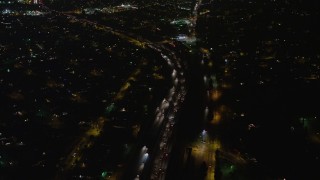 AX64_0436 - 5K aerial stock footage of freeway traffic on Interstate 5 through Sun Valley, California night