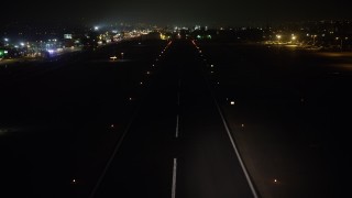 AX64_0447 - 5K aerial stock footage of landing on the runway at Whiteman Airport, Pacoima, California, night