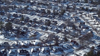 AX66_0009E - 4.8K aerial stock footage of a snow covered neighborhood, Plainview, New York