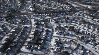 AX66_0013 - 4.8K aerial stock footage of suburban neighborhoods in snow, Syosset, New York