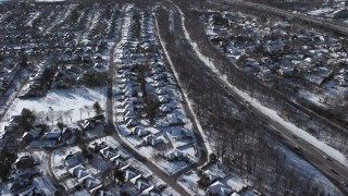 AX66_0014 - 4.8K aerial stock footage of neighborhoods and highway in snow, Syosset, New York