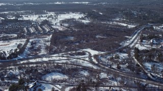 AX66_0016 - 4.8K aerial stock footage of flying towards forests in snow, Jericho, New York