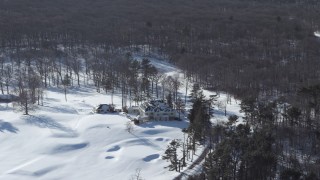 AX66_0017 - 4.8K aerial stock footage of a snow covered mansion, Jericho, New York