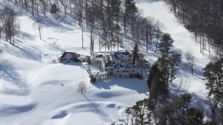 AX66_0018 - 4.8K aerial stock footage of flying by a mansion in snow, Jericho, New York