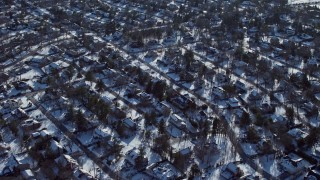 AX66_0024E - 4.8K aerial stock footage of a snow covered suburban neighborhoods, East Hills New York