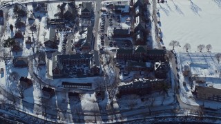 AX66_0038 - 4.8K aerial stock footage of a bird's eye view of a military base in snow, Fort Totten, New York