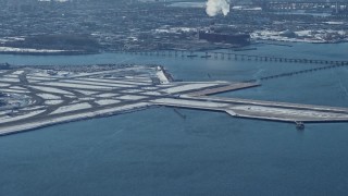 AX66_0043E - 4.8K aerial stock footage track passenger jet landing LaGuardia Airport, New York