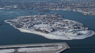 AX66_0047 - 4.8K aerial stock footage video of the prison on Rikers Island in snow New York