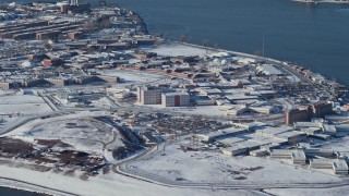 AX66_0048 - 4.8K aerial stock footage of prison buildings on Rikers Island in snow New York