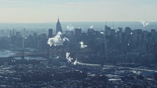 AX66_0051 - 4.8K aerial stock footage of smoke stacks and skyscrapers in Midtown Manhattan, New York