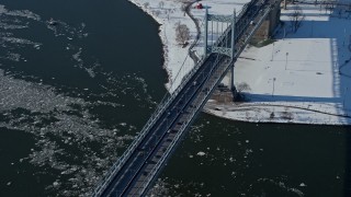 AX66_0053E - 4.8K aerial stock footage of Robert F Kennedy Bridge and icy Harlem River, New York