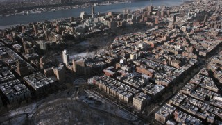 AX66_0059 - 4.8K aerial stock footage tilt from Central Park to reveal Columbia University with snow, New York City