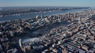 AX66_0059E - 4.8K aerial stock footage tilt from Central Park to reveal Columbia University with snow, New York City