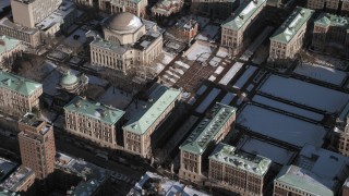 AX66_0066 - 4.8K aerial stock footage orbit the Columbia University campus and library with snow, New York City