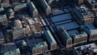 AX66_0066E - 4.8K aerial stock footage orbit the Columbia University campus and library with snow, New York City