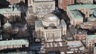 AX66_0072 - 4.8K aerial stock footage orbit Columbia University's Low Memorial Library with snow, New York City