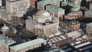 AX66_0073 - 4.8K aerial stock footage of Low Memorial Library at Columbia University with snow, New York City