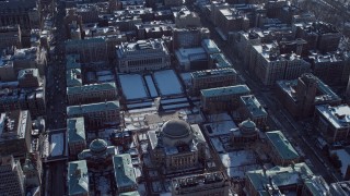 AX66_0076E - 4.8K aerial stock footage orbit around the Columbia University campus with snow, New York City