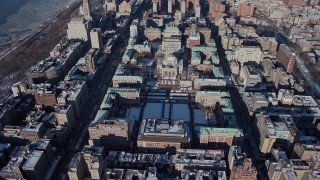 AX66_0080E - 4.8K aerial stock footage of circling around the Columbia University campus with snow, Morningside Heights, New York City