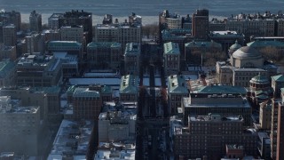 AX66_0091E - 4.8K aerial stock footage of snowy grounds and the Graduate School of Journalism at Columbia University, New York City