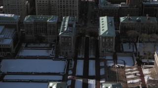 AX66_0092 - 4.8K aerial stock footage fly over snowy Columbia University to approach the Graduate School of Journalism, New York City