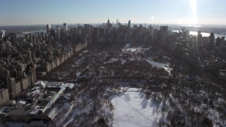 AX66_0105 - 4.8K stock footage aerial video fly over snowy Central Park and the Metropolitan Museum of Art toward Midtown, New York City