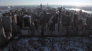AX66_0107 - 4.8K aerial stock footage tilt from Central Park to reveal Midtown Manhattan in winter, New York City