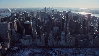 AX66_0107E - 4.8K aerial stock footage tilt from Central Park to reveal Midtown Manhattan in winter, New York City
