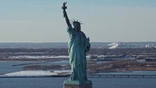 AX66_0132 - 4.8K aerial stock footage of an orbit of the Statue of Liberty in winter, New York