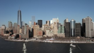 AX66_0135 - 4.8K aerial stock footage approach Battery Park in snow in Lower Manhattan, New York City