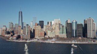 AX66_0135E - 4.8K aerial stock footage approach Battery Park in snow in Lower Manhattan, New York City