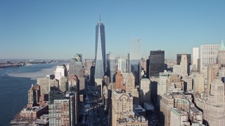 AX66_0137E - 4.8K aerial stock footage approach Freedom Tower and tilt to World Trade Center Memorial with snow, New York City