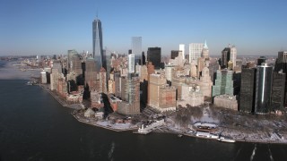 AX66_0155 - 4.8K stock footage aerial video of One World Trade Center and Lower Manhattan skyscrapers in snow, New York City