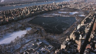 AX66_0191 - 4.8K stock footage aerial video of Jacqueline Kennedy Onassis Reservoir in Central Park in snow, New York City