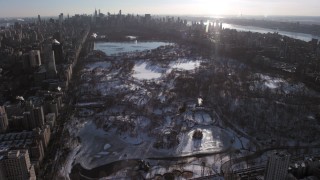 AX66_0196 - 4.8K stock footage aerial video of orbit Central Park in snow, tilt to reveal Midtown Manhattan, New York City