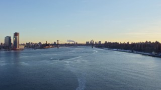 AX66_0228 - 4.8K aerial stock footage follow East River to approach Williamsburg Bridge, New York City at sunset