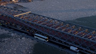 AX66_0230E - 4.8K aerial stock footage approach and pan across heavy traffic on Williamsburg Bridge, New York City, sunset