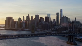 AX66_0232E - 4.8K aerial stock footage approach Manhattan Bridge, Brooklyn Bridge and Lower Manhattan, New York City, sunset