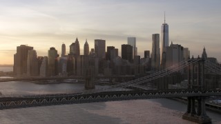 AX66_0233 - 4.8K stock footage aerial video approach Manhattan Bridge, Brooklyn Bridge and Lower Manhattan, New York City, sunset