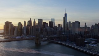 AX66_0234 - 4.8K aerial stock footage approach Brooklyn Bridge and Lower Manhattan skyline, New York City, sunset