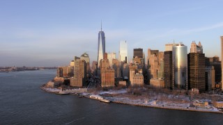 AX66_0240 - 4.8K stock footage aerial video of One World Trade Center and Battery Park with snow, Lower Manhattan, New York City, sunset