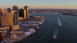 AX66_0257 - 4.8K stock footage aerial video of ferries on East River by Battery Park, Lower Manhattan in snow, New York City, sunset
