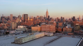 AX66_0269 - 4.8K aerial stock footage a view of the Empire State Building from Chelsea Piers, Midtown Manhattan, New York City, sunset