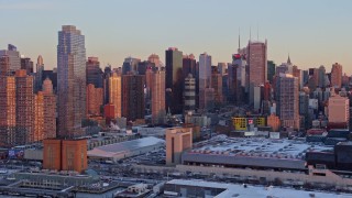 AX66_0271E - 4.8K aerial stock footage of Midtown Manhattan's Hell's Kitchen in winter, New York City, sunset