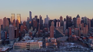 AX66_0274E - 4.8K aerial stock footage of Hell's Kitchen, Midtown Manhattan, and Upper West Side in winter, New York City, sunset